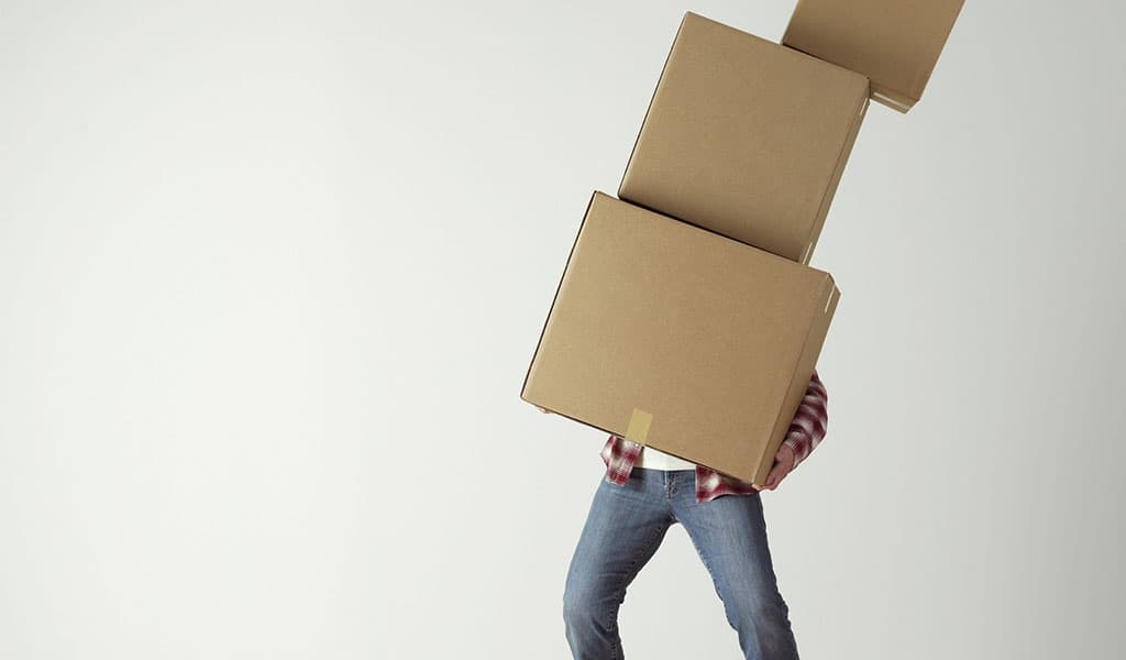 man holding 3 boxes